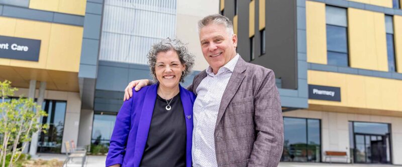 Kristie Gallo, Account Executive at PetleyHare and Keith White, CEO at Oshawa Clinic Group in front of Whitby Health Centre